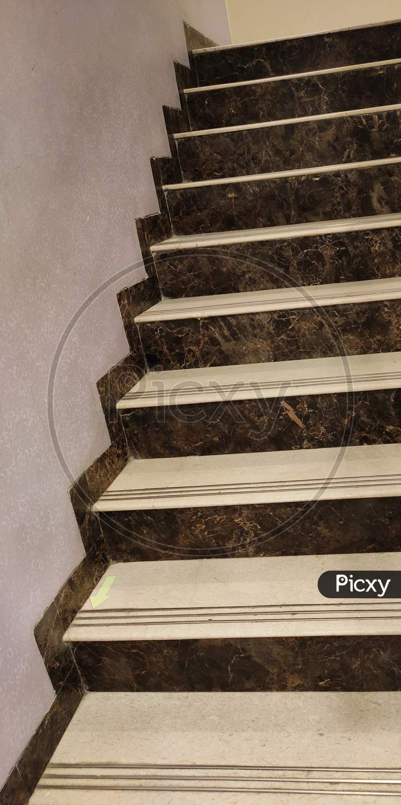 Symmetric stairs made up of white and brown marble