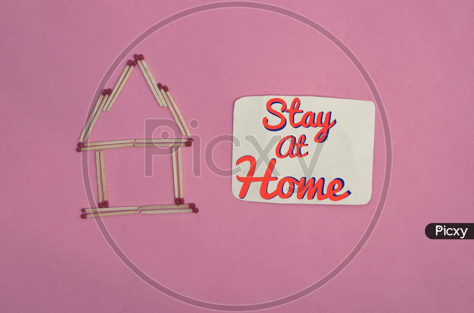 Stay At Home Conceptual Photo With Match Stick Made House Isolated On Pink Background