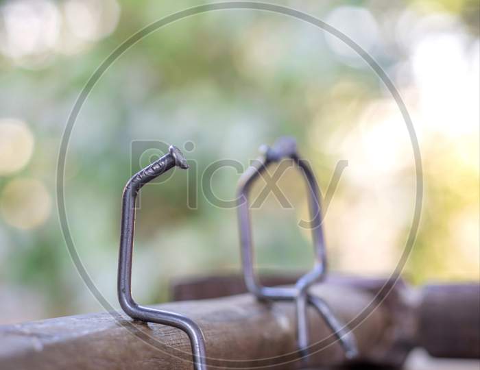 Creative Photography Of Single Man Or Woman Sitting Using Nails Screw
