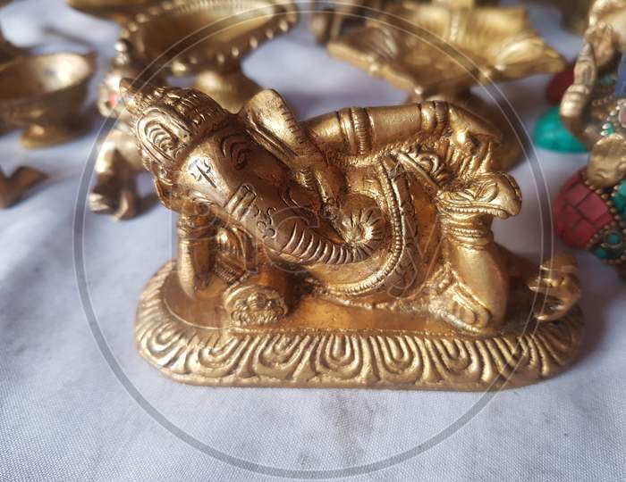 Gold colour metal hindu statue of god idols in home