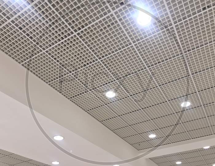 An White Painted Emulsion Painted For An Gypsum Ceiling With Macro Grid Ceiling For An Suspended False Ceiling Of An Shopping Mall Interiors Architecture Work In Muscat Oman