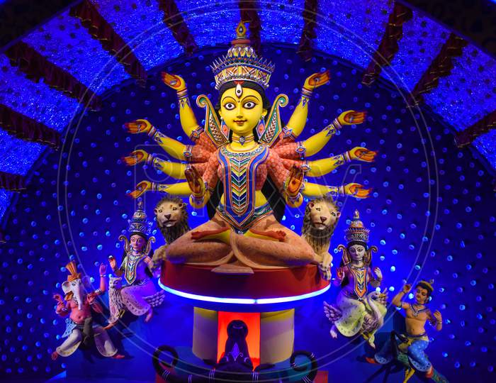 Goddess Durga Idol At Decorated Durga Puja Pandal, Shot At Colored Light, At Kolkata, West Bengal, India. Durga Puja Is Biggest Religious Festival Of Hinduism And Is Now Celebrated Worldwide