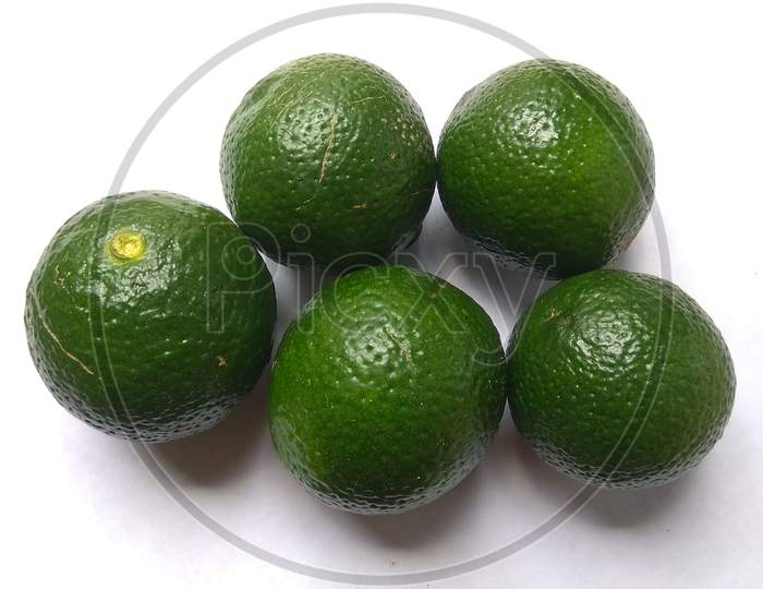 Fresh green lemons isolated on white background.