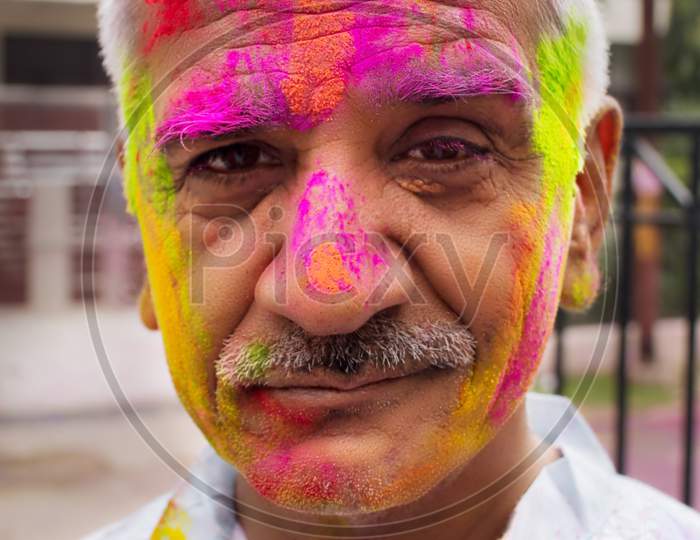 Man With Holi Colors On Face.