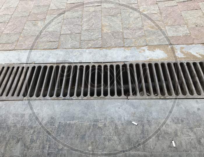 Channel Gratings Made Of Ductile Iron Material For Drainage Purpose At An Car Cleaning Location So That Dirty Water Runs Towards Through This Gratings To Manhole