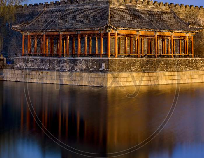 Northwestern Tower Of The Forbidden City Reflecting In The Water In Beijing
