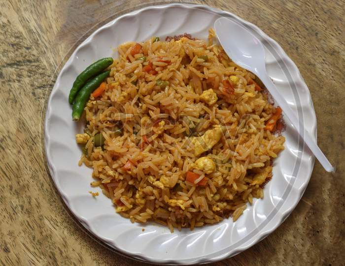 Fried Rice Is A Dish Of Cooked Rice That Has Been Stir-Fried In A Wok Or A Frying Pan And Is Usually Mixed With Other Ingredients Such As Eggs, Vegetables, Seafood, Or Meat.