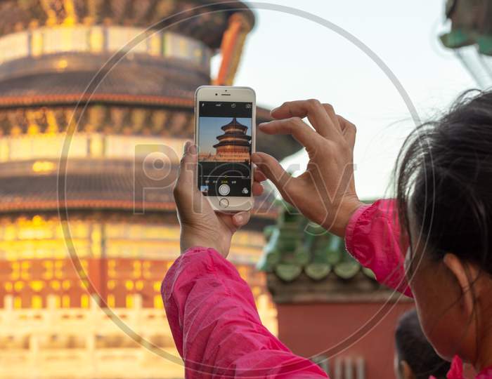 Woman Photographing Temple Of Heaven In Beijing, China