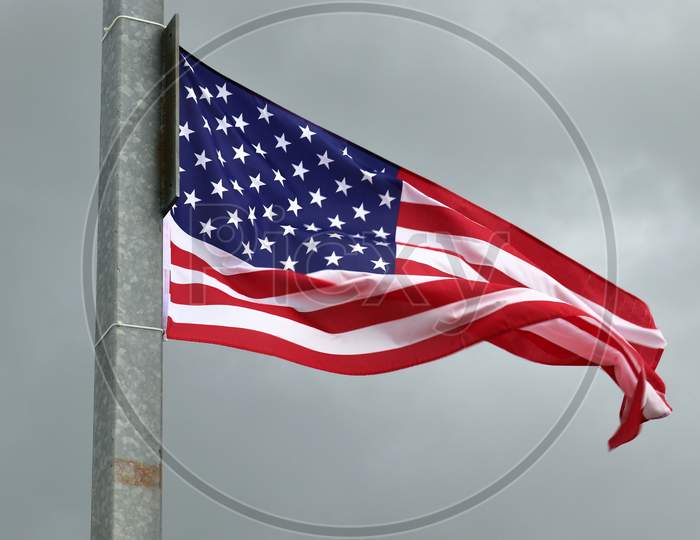Close up view at a national USA flag moving in heavy wind