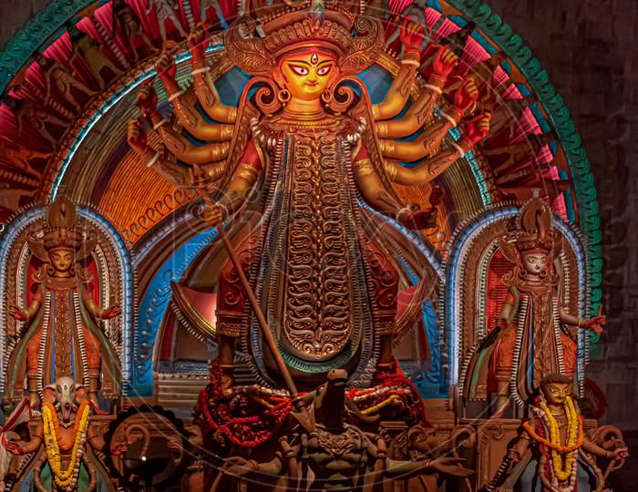 Goddess Durga Idol At Decorated Durga Puja Pandal, Shot At Colored Light, In Kolkata, West Bengal, India. Durga Puja Is Biggest Religious Festival Of Hinduism And Is Now Celebrated Worldwide.