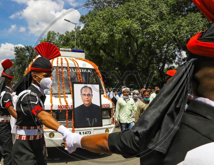 Army personnel escort an ambulance carrying the body of late former India's President Pranab Mukherjee as they leave his residence ahead of his funeral in New Delhi on September 1, 2020.