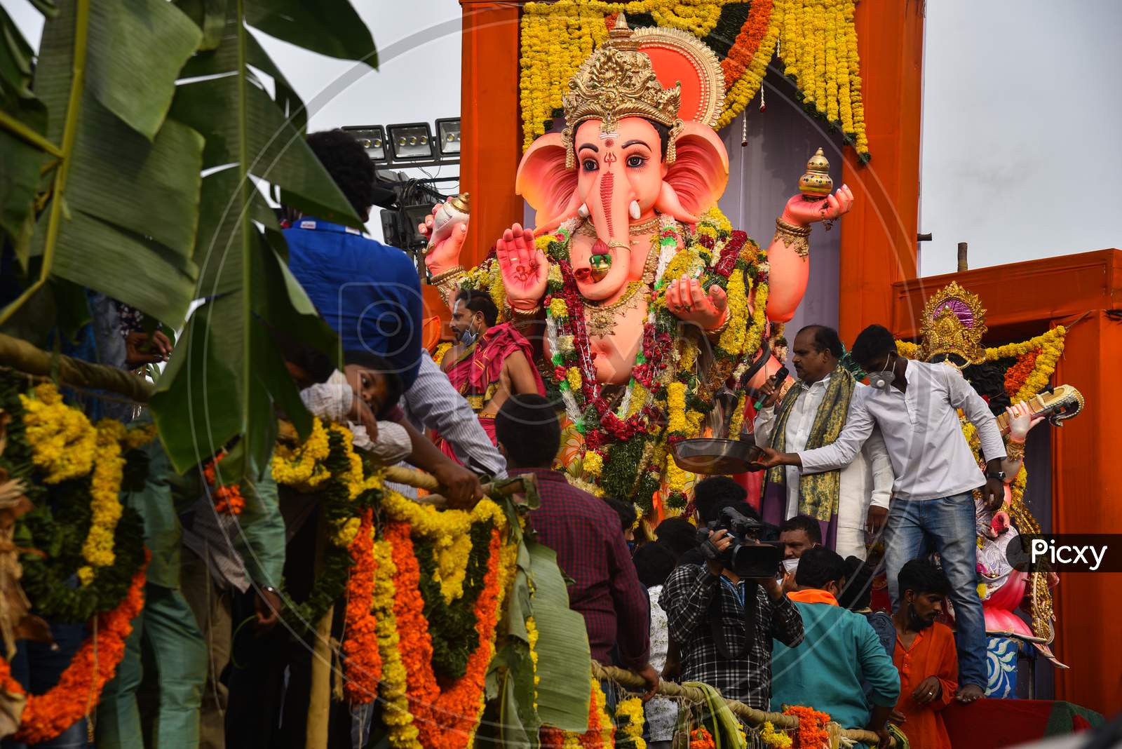 People flout social distancing norms to participate in a procession of Khairatabad Ganesh Idol Immersion in Hyderabad on September 1, 2020.