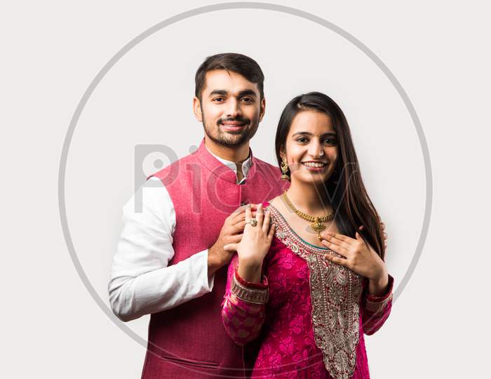 Handsome Young Indian Man Presenting Expensive Gold Necklace To Pretty Young Girl Friend Or Wife