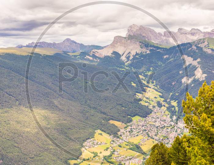 Alpe Di Siusi, Seiser Alm With Sassolungo Langkofel Dolomite, A Tree With A Mountain In The Background