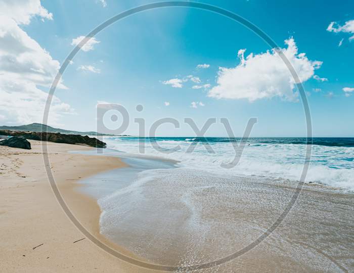 Wide Angle Image Of A Wild Beach On The North Of Spain During A Sunny Day With A Clear Sky