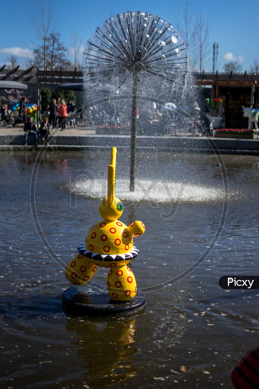 Flower Garden, Netherlands , A Yellow Fire Hydrant Sitting In The Water