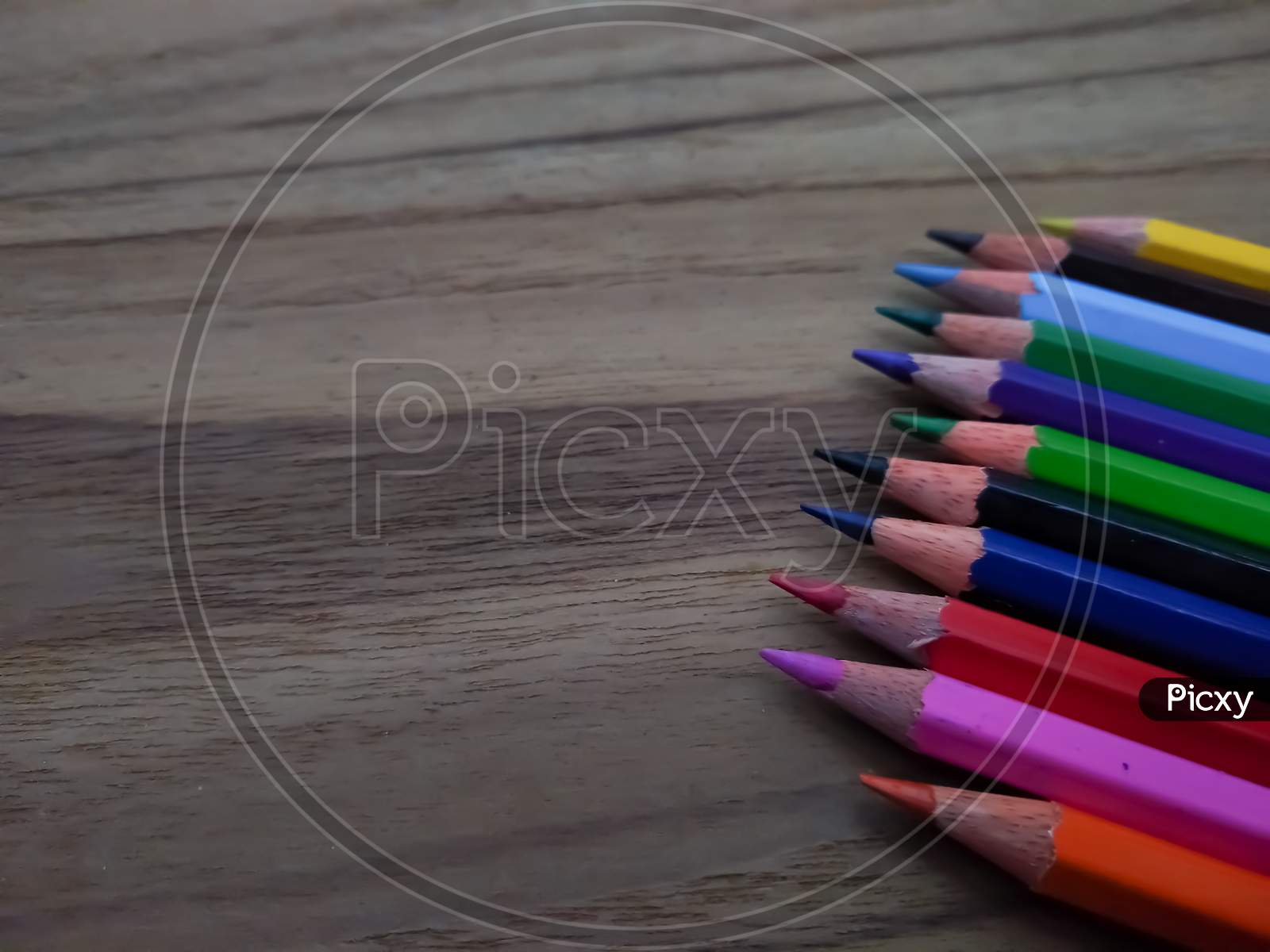 Colour pencils on wooden background