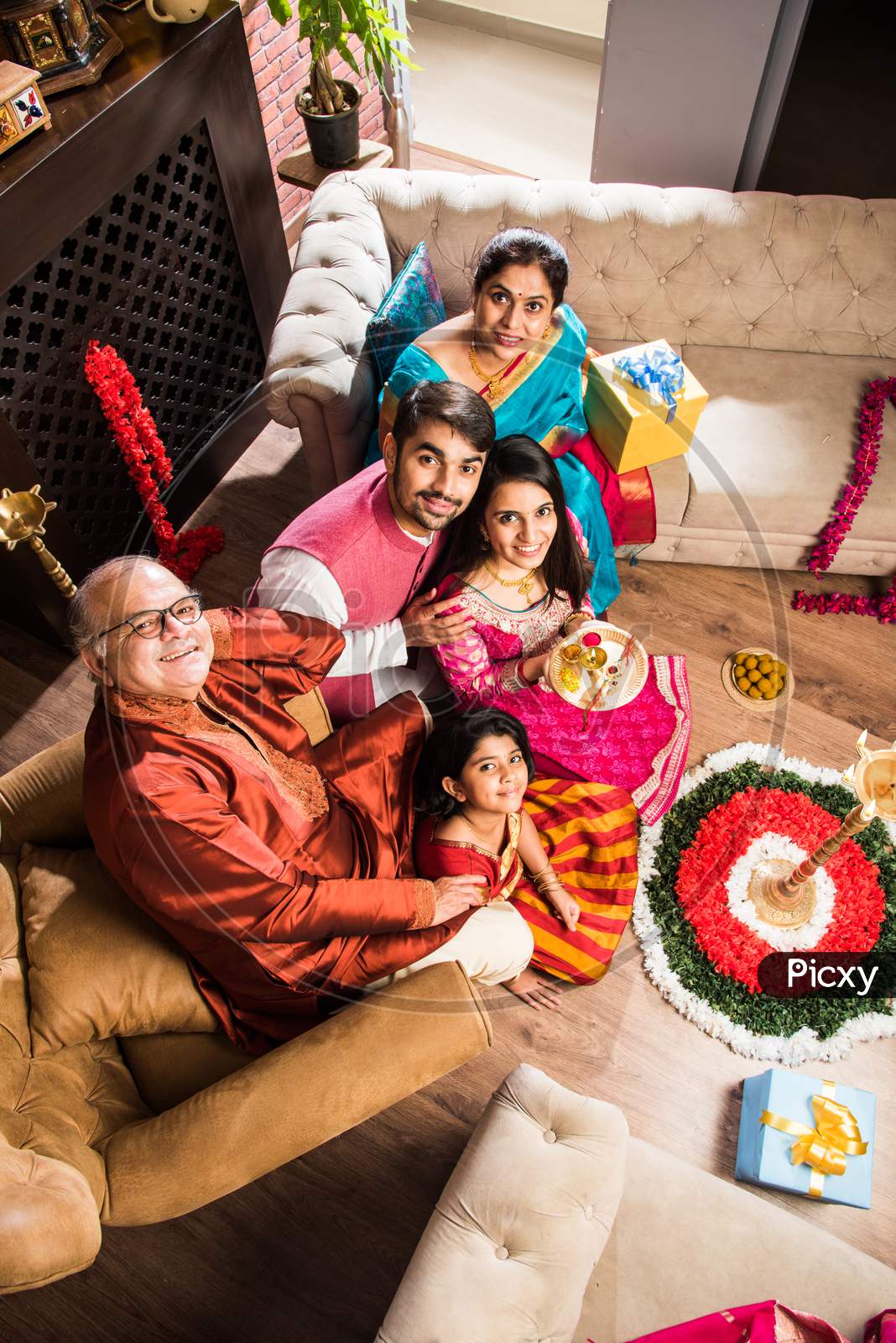 Happy Indian Family Performing Puja Or Pooja On Ganesh Chaturthi Festival