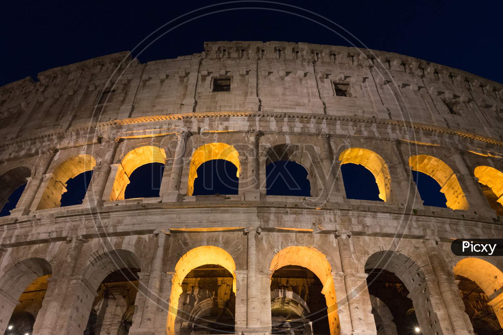 Night At The Great Roman Colosseum (Coliseum, Colosseo), Also Known As The Flavian Amphitheatre With Lights & Illumination.