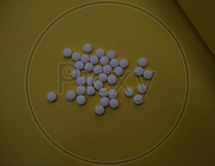 Medicinal Tablets on yellow background