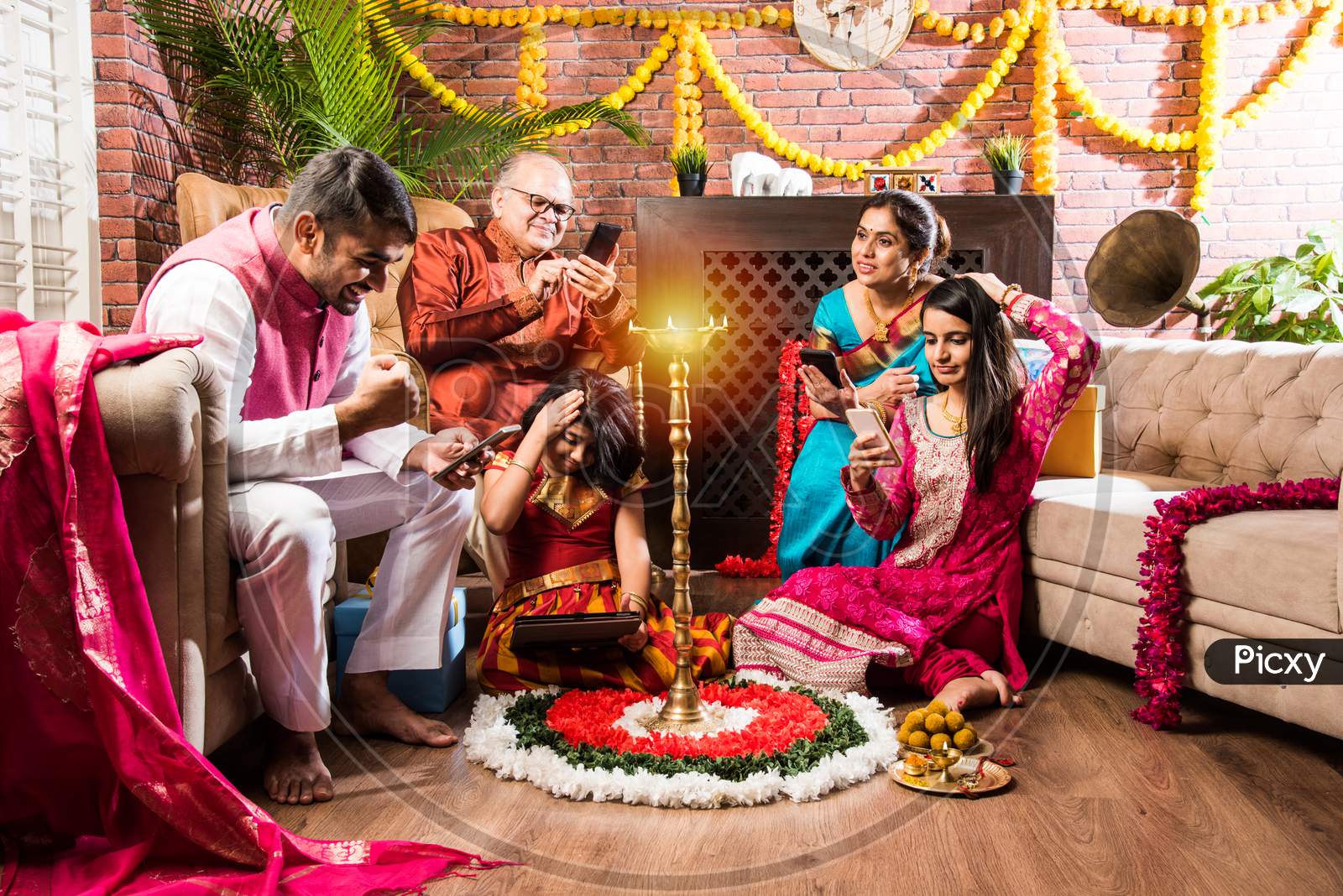 Multigenerational Indian Family Addicted To Mobile Phone Or Using Smartphone In Diwali Festival