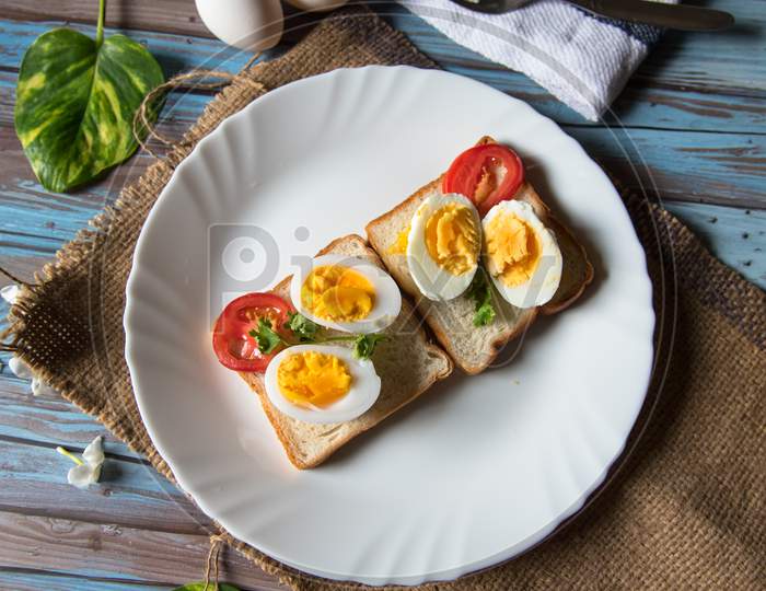 Bread slices with condiments of egg and vegetables with a view from top