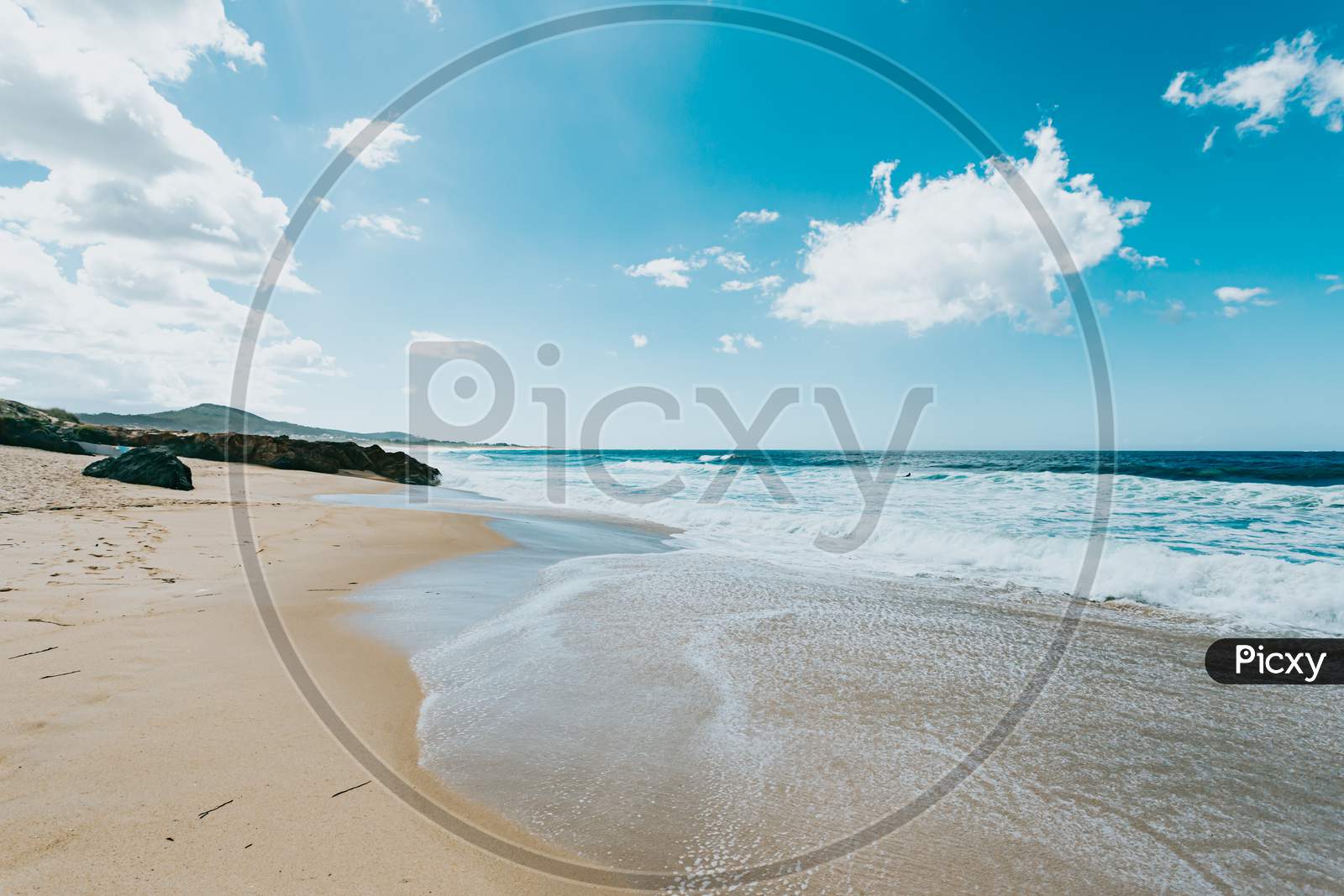 Wide Angle Image Of A Wild Beach On The North Of Spain During A Sunny Day With A Clear Sky
