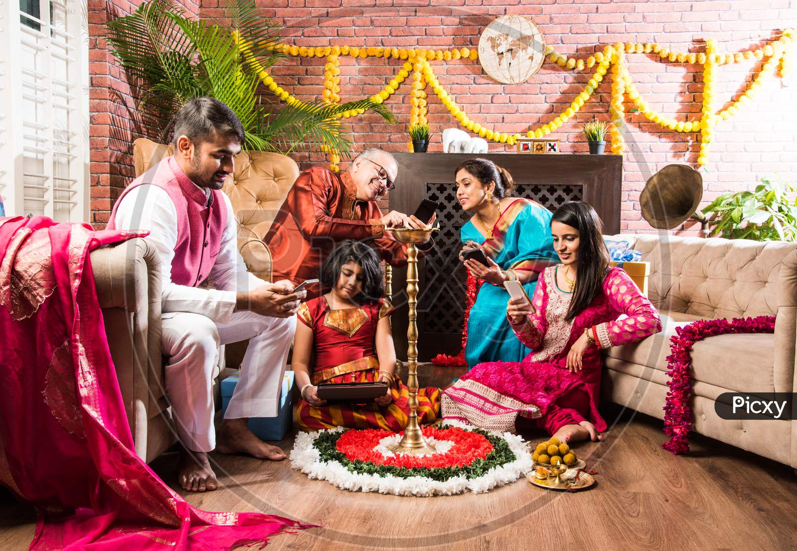 Multigenerational Indian Family Addicted To Mobile Phone Or Using Smartphone In Diwali Festival