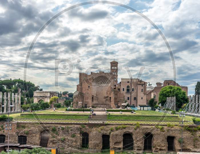 Rome, Italy - 23 June 2018: The Ancient Ruins At The Roman Forum Of Temple Of Venus And Roma At Rome Viewed From The Colosseum. Famous World Landmark. Scenic Urban Landscape.