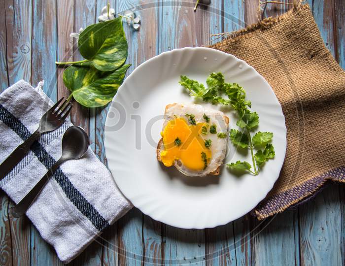 Egg poach on bread with condiments on a background