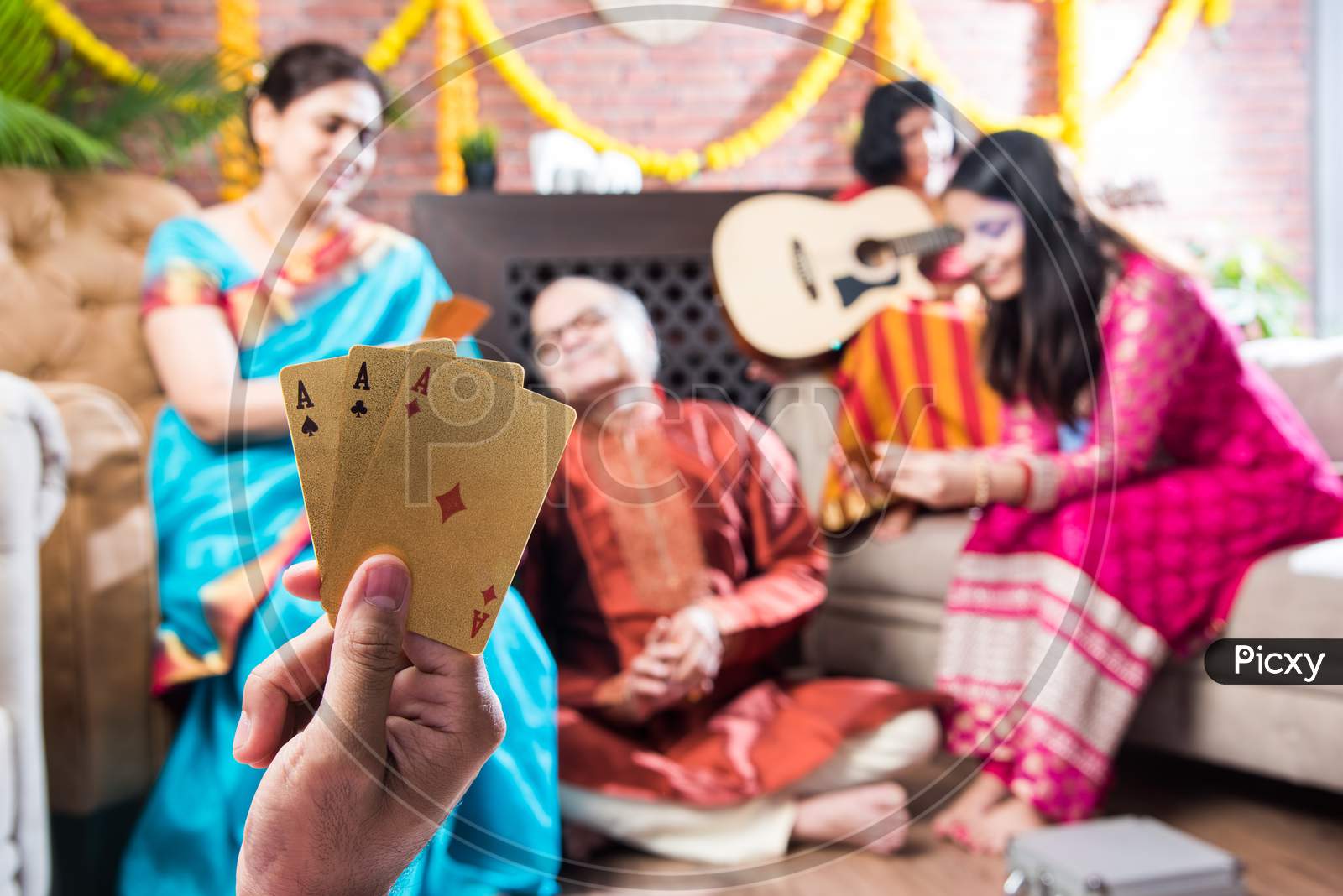 Indian Family Playing Three Cards Or Teen Patti In Diwali Or Deepavali Festival At Home