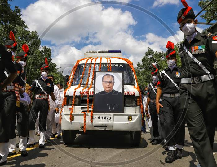 Army personnel escort an ambulance carrying the body of late former India's President Pranab Mukherjee as they leave his residence ahead of his funeral in New Delhi on September 1, 2020.
