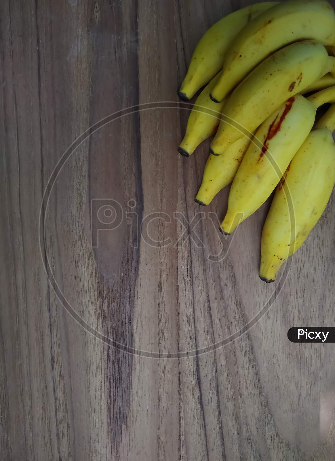 Fresh ripened banana on wooden background