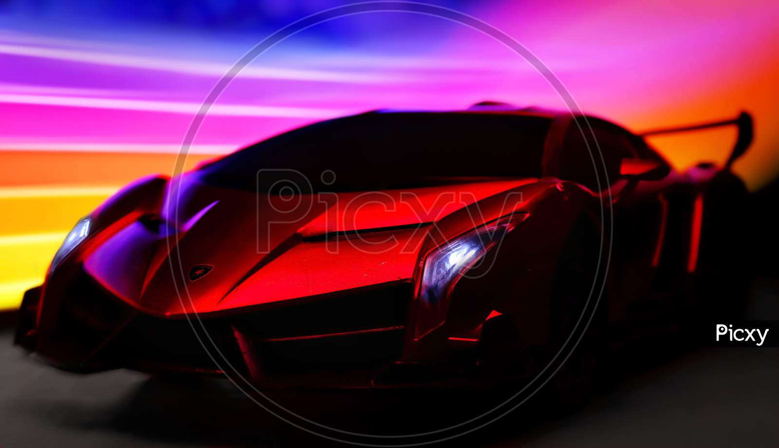 Toy Lamborghini with light painting in background