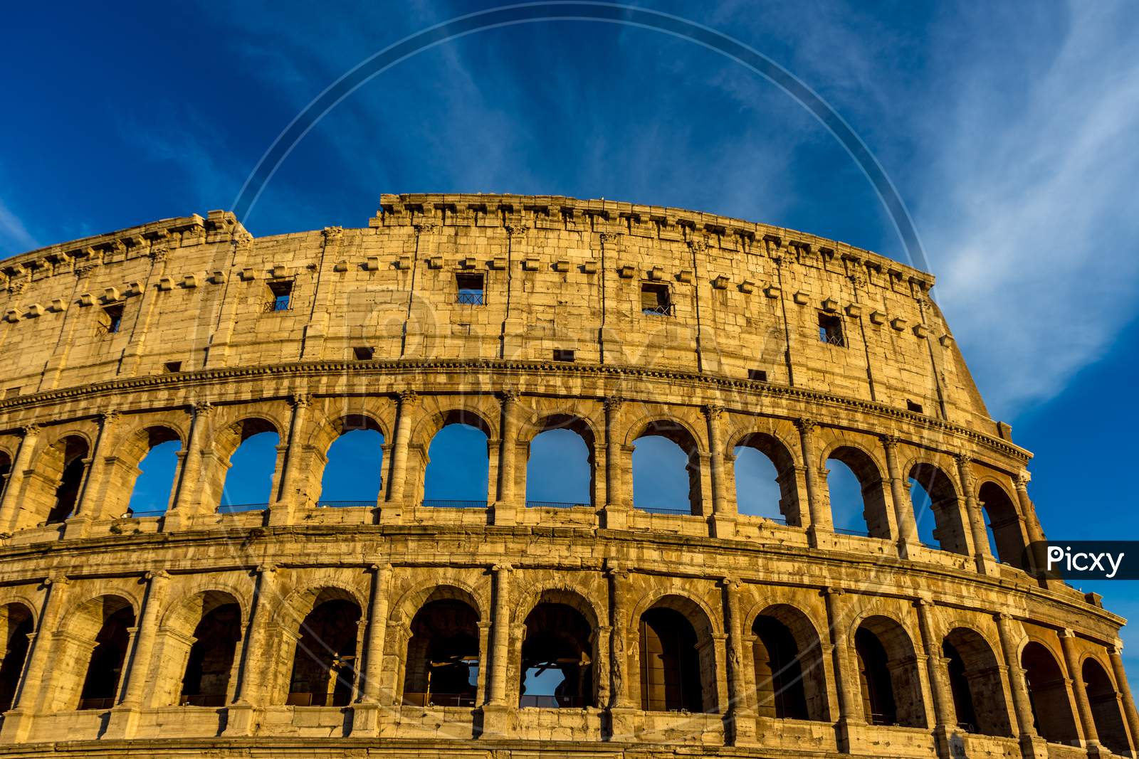 Golden Sunset At The Great Roman Colosseum (Coliseum, Colosseo), Also Known As The Flavian Amphitheatre. Famous World Landmark. Scenic Urban Landscape.