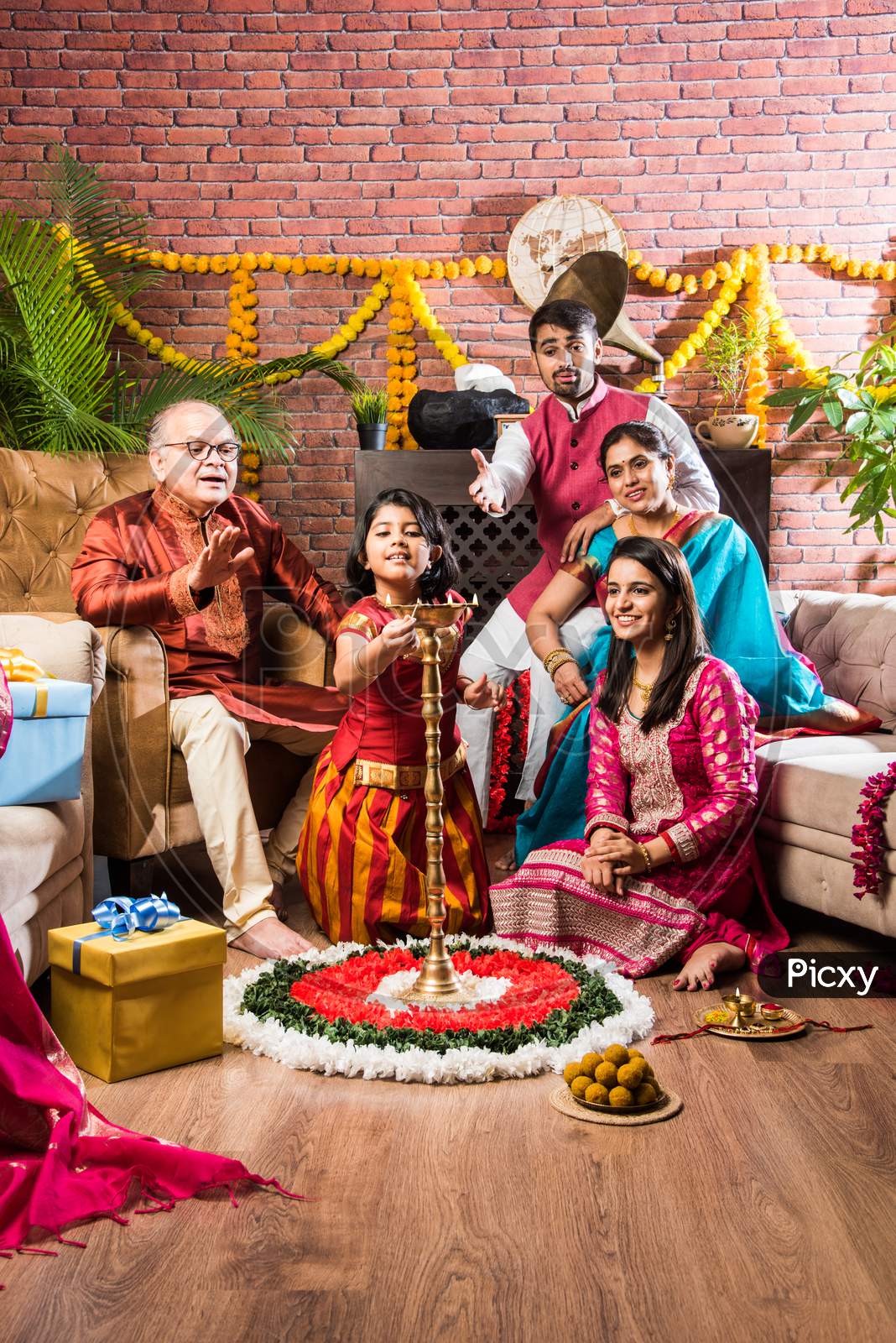 Happy Indian Family Performing Puja Or Pooja On Ganesh Chaturthi Festival