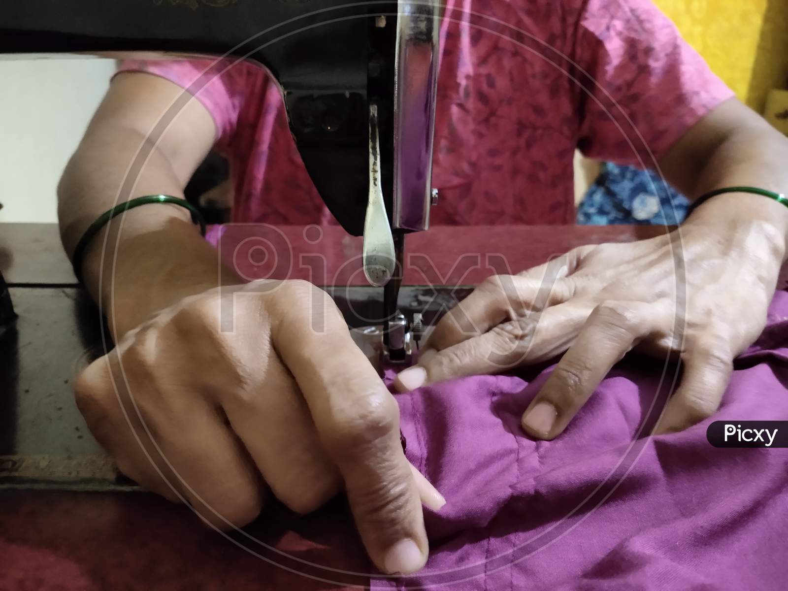 Tailoring work- Indian woman sewing clothes