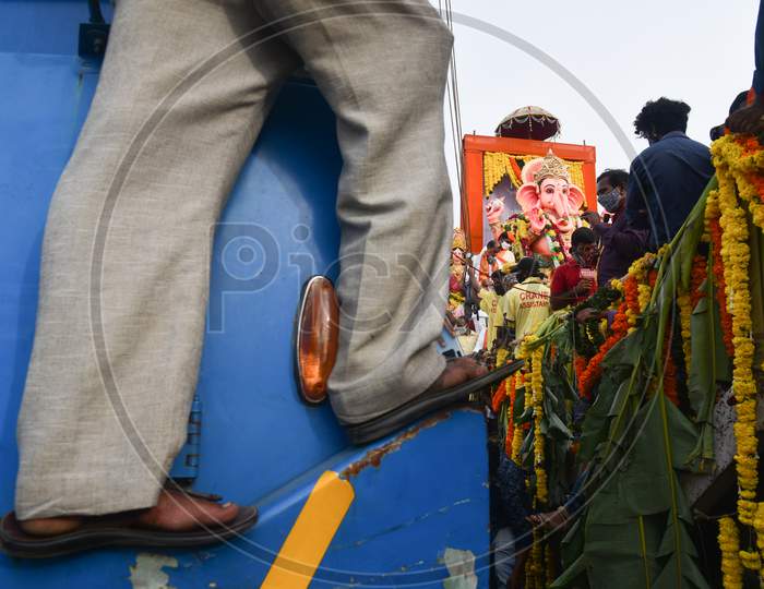 People flout social distancing norms to participate in a procession of Khairatabad Ganesh Idol Immersion in Hyderabad on September 1, 2020.
