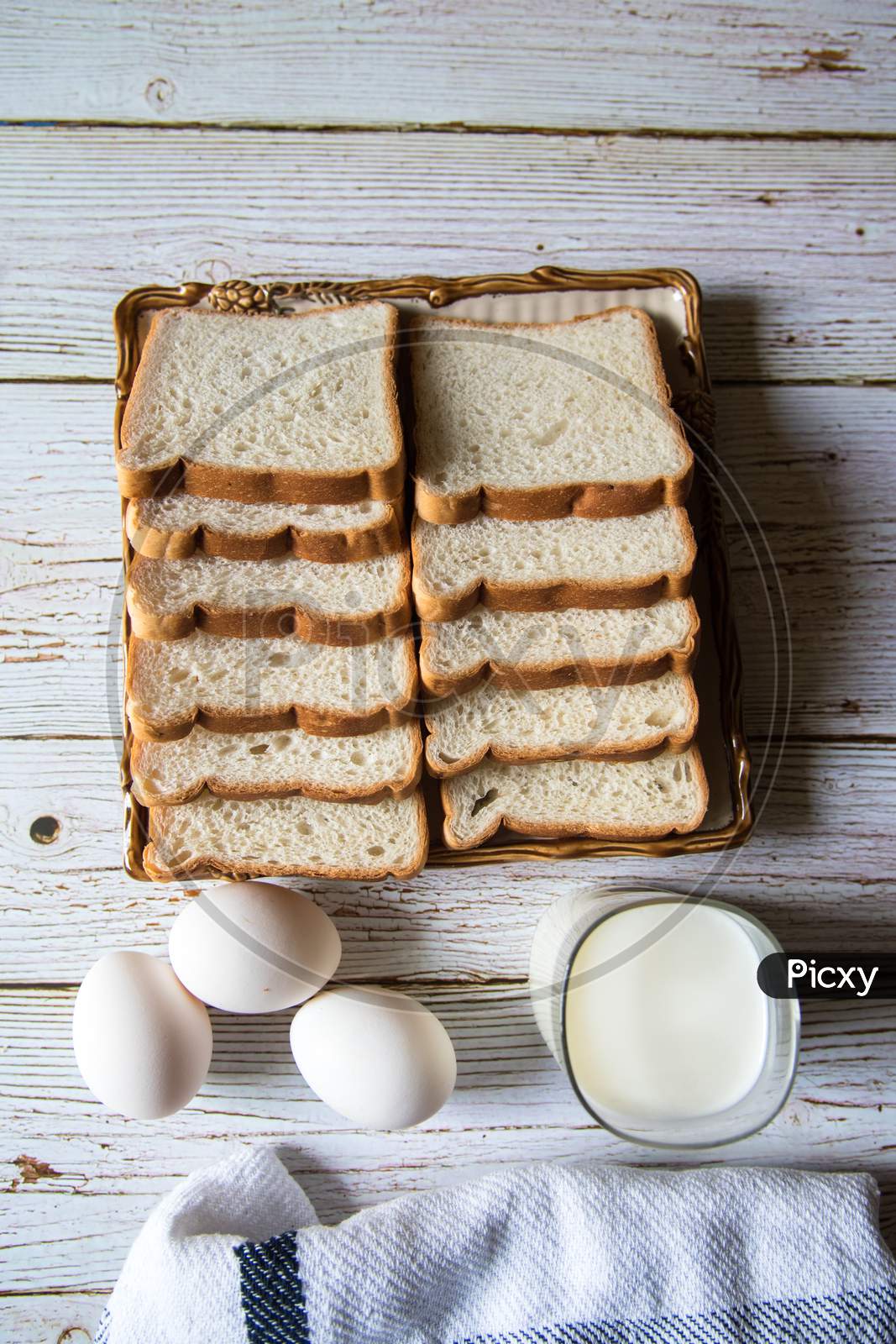 Top view of bread slices, egg and a glass of milk