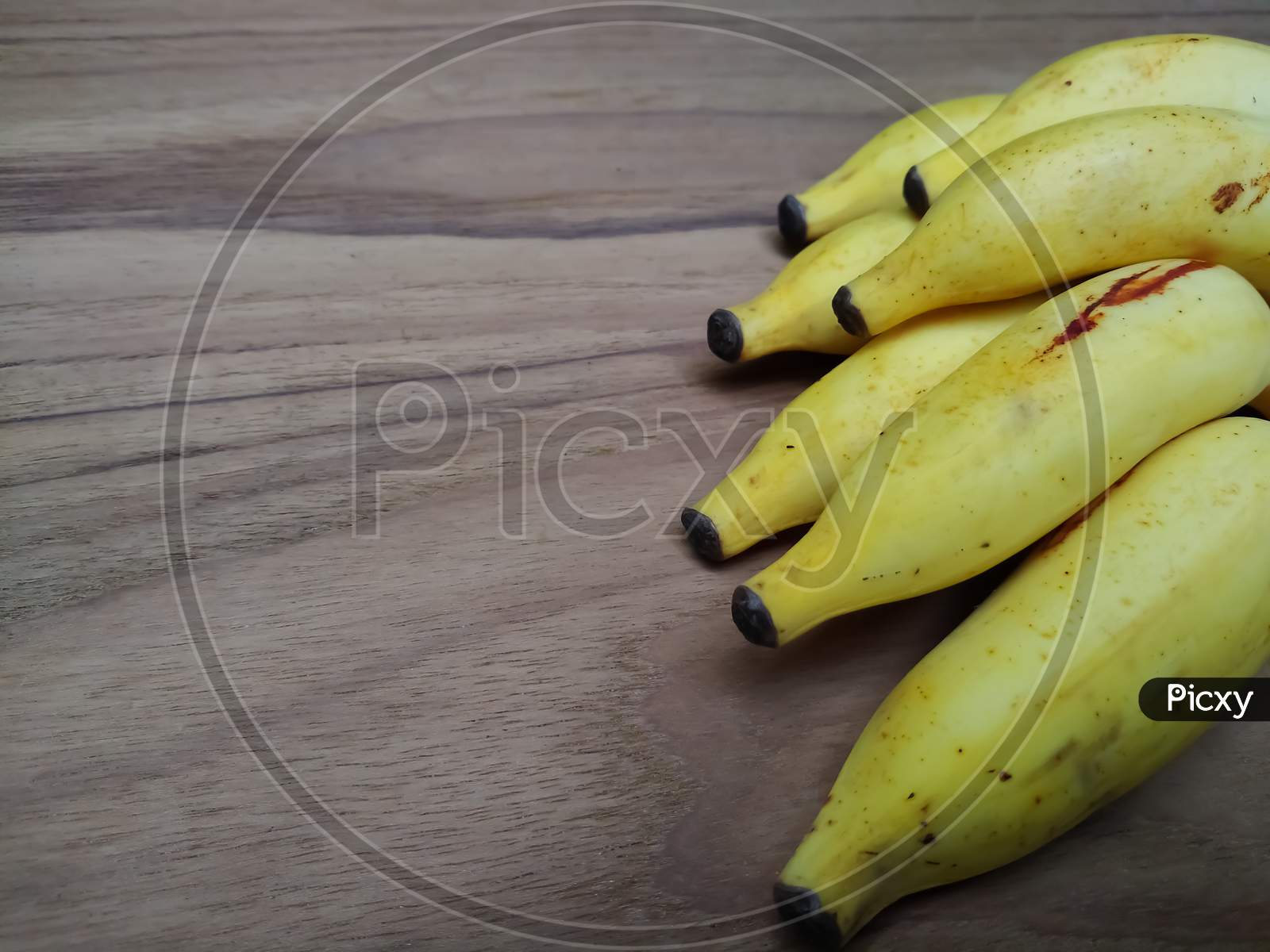 Fresh ripened banana on wooden background