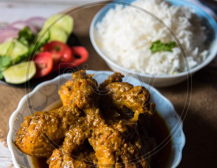Close up of fried chicken wings with rice with salad prepared Indian style