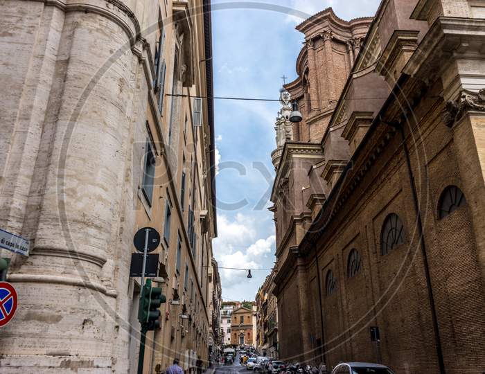 Rome, Italy - 24 June 2018: A Narrow City Street With Buildings On The Side Of A Building In Rome, Italy