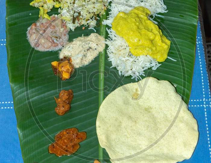 Traditional Kerala food laid out on a banana leaf during the Onam festival