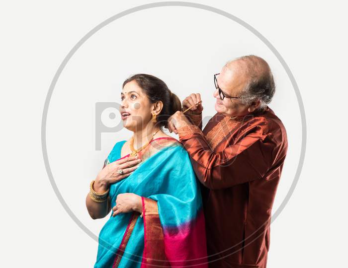 Handsome Retired Indian Man Presenting Expensive Gold Necklace To Pretty Wife