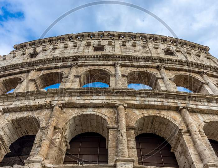Facade Of The Great Roman Colosseum (Coliseum, Colosseo), Also Known As The Flavian Amphitheatre. Famous World Landmark. Scenic Urban Landscape.