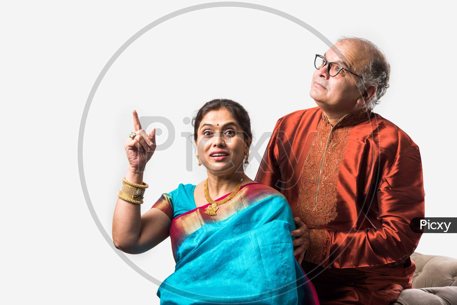 Portrait Of Happy Indian Old Couple Or Senior Adults In Traditional Ethnic Attire Or Party Wear