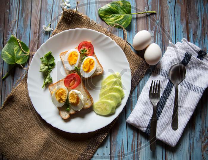 Top view of healthy food ingredients of boiled eggs, bread and vegetables