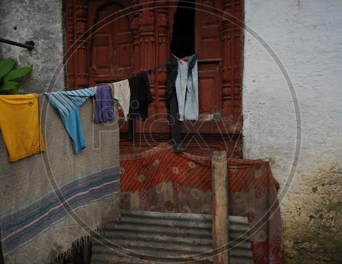Clothes Hanging On A Rope Tied With A Red Old Vintage Window.
