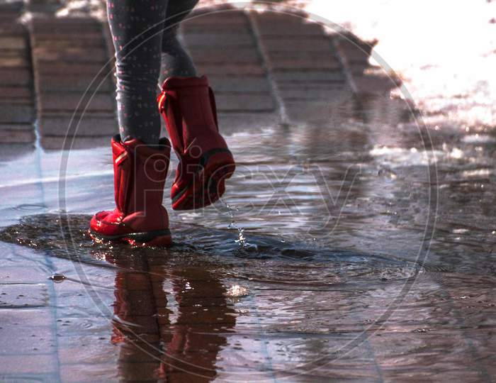 red,cowboy boot,leg,shoe,footwear,water,boot,reflection