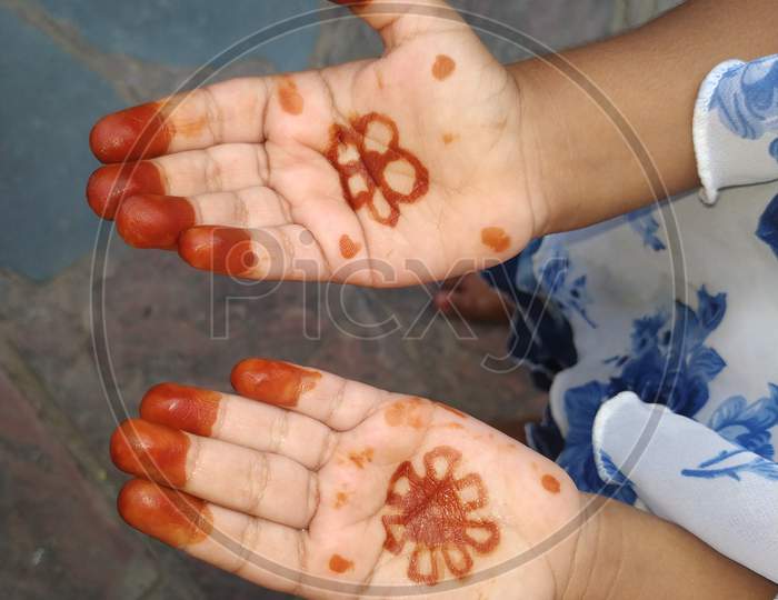 Baby girl hand with mehndi design